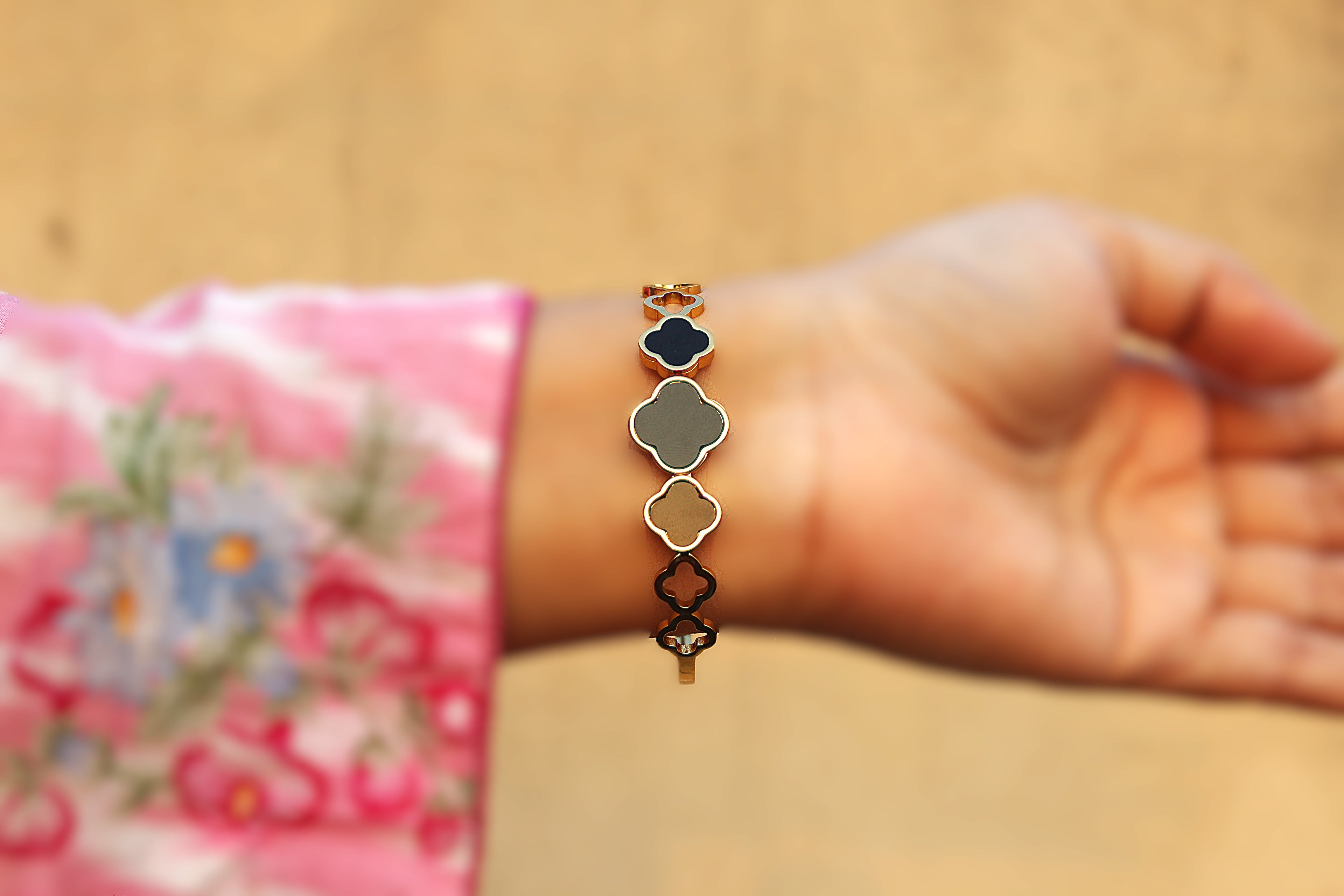 Modern Elegance: Stainless Steel Bangle with 1 Carat Gold Polish and Black Clover Design